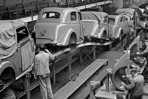 Schwarzweißbild einer Autofabrik. Arbeitsmediz und Arbeitssicherheit waren früher keine Selbstverständlichkeit. © Shutterstock, Vyntage Visuals